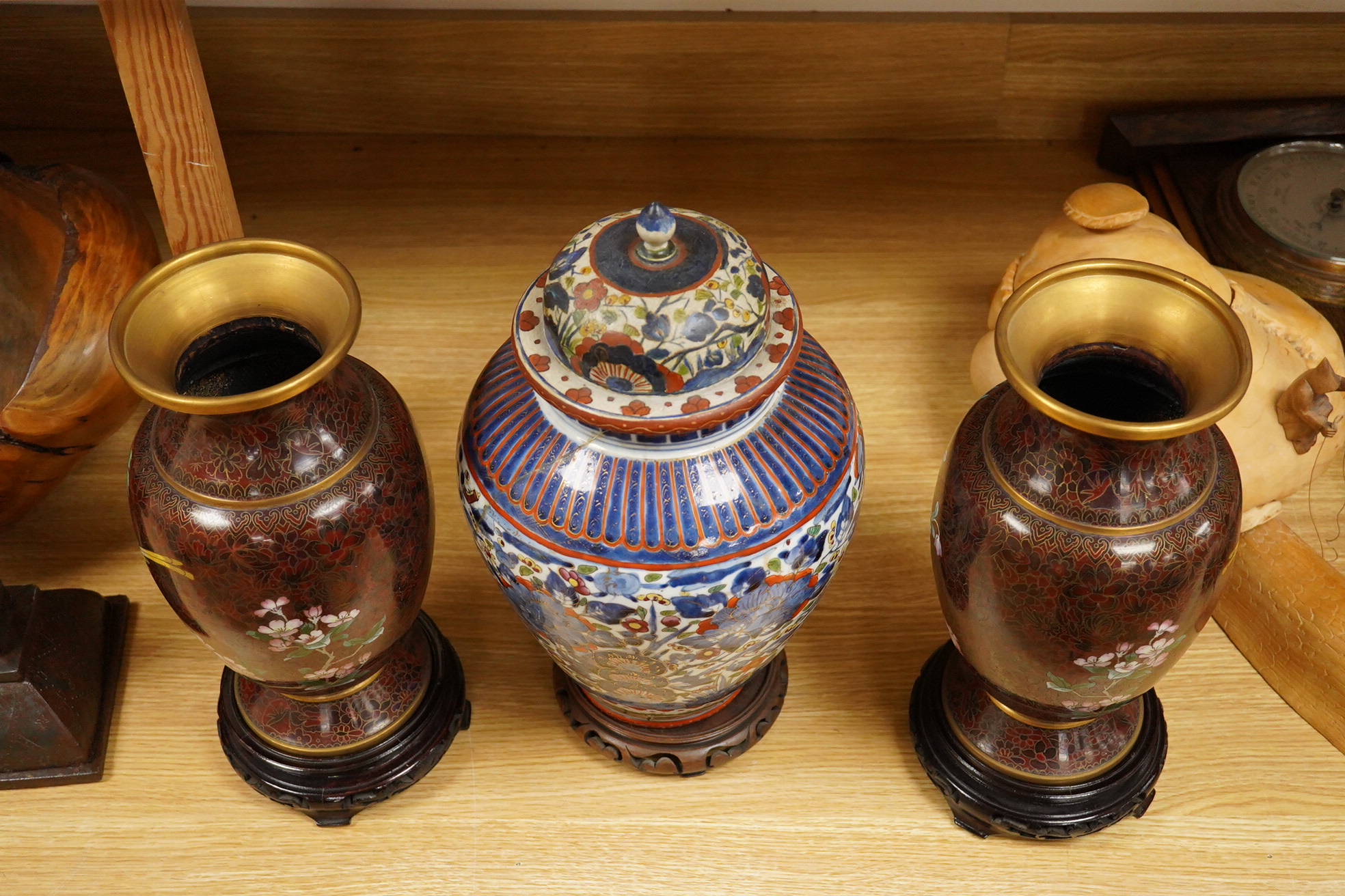 A pair of cloisonné vases on stands and Chinese clobbered vase and cover on stand (damaged). 44cm high